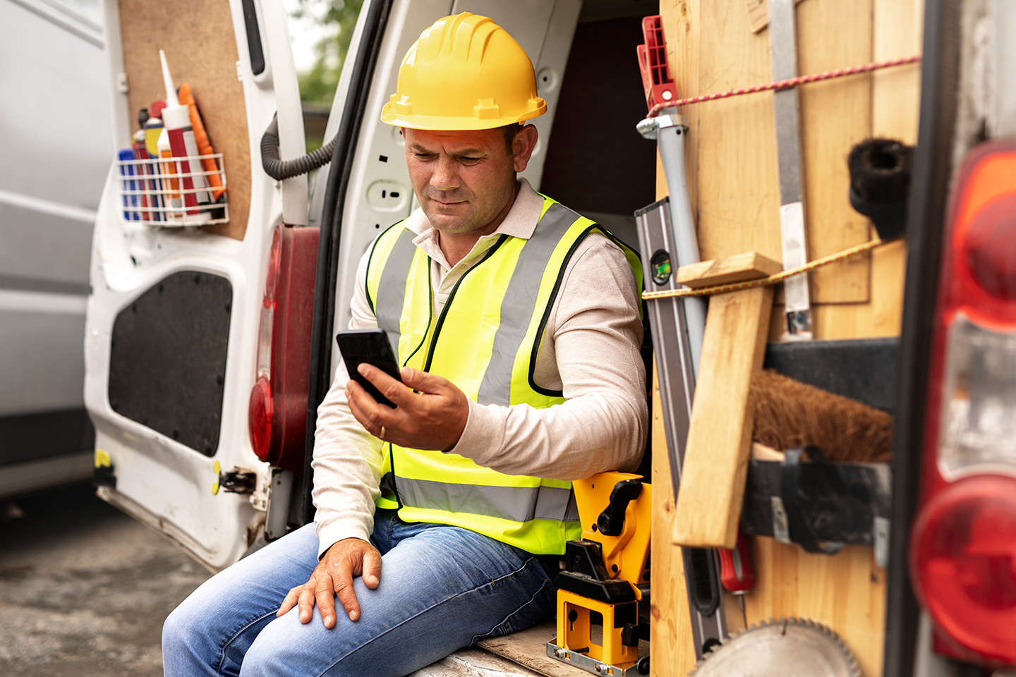 A field services technician uses a work order management system on a smartphone