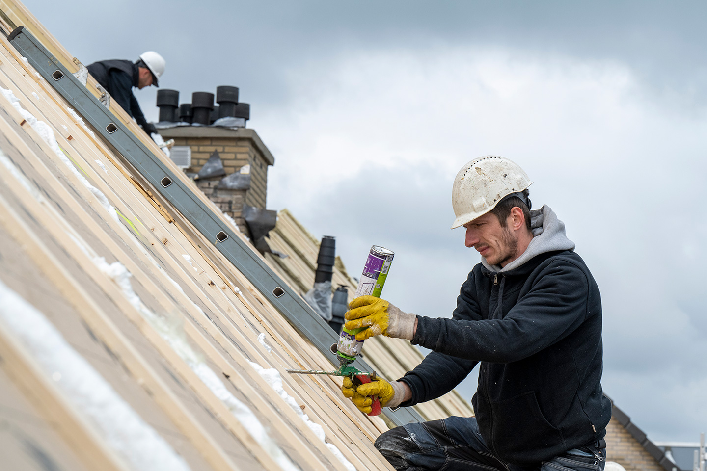 Roofers working a job scheduled with AI tools for roofers